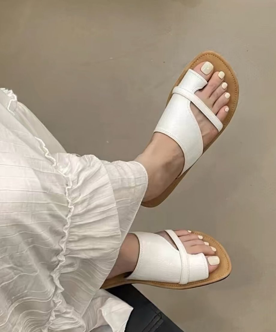 白いギャザースカートにホワイトのサンダルを合わせた清涼感のあるスタイル