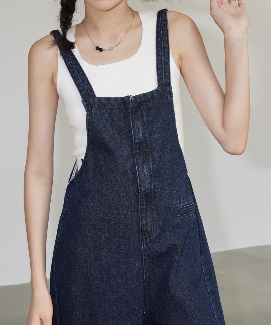デニムサロペットを着用した女性のフロントショット。ゆったりとした腰回りのデザイン